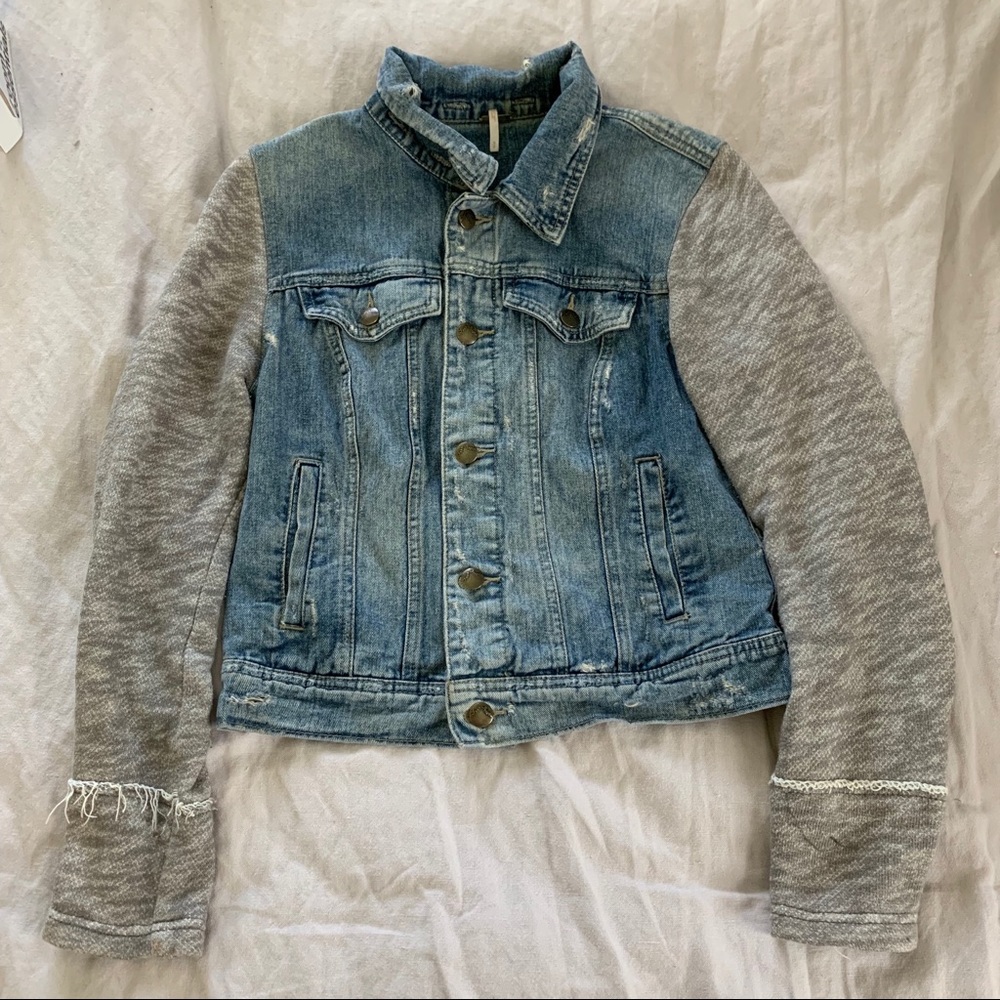 Distressed jean jacket with sweater sleeves